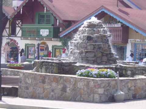 1988 Ford Bronco - A stone fountain with flowers is in front of shops with Bavarian architecture.