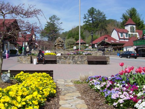 1988 Ford Bronco - A town square scene with colorful flowers and a single car on the road.