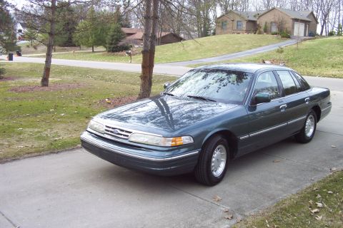1996 Ford Crown Victoria - Green Ford Crown Victoria sedan parked on a suburban driveway.