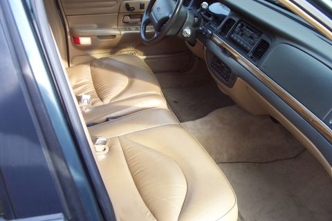 1996 Ford Crown Victoria - Interior view of a 1996 Ford Crown Victoria, highlighting the tan leather seats and dashboard details.