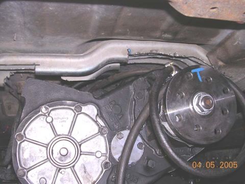 1994 Ford Bronco - Underside view of vehicle's drivetrain components, including the transfer case and driveshaft connection.