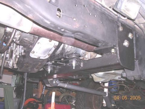 1994 Ford Bronco - The underside of a vehicle is captured, revealing mechanical parts and suspension systems.