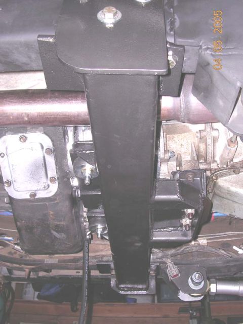 1994 Ford Bronco - Close-up of the undercarriage shows a heavy-duty crossmember installed near the transmission and exhaust system.