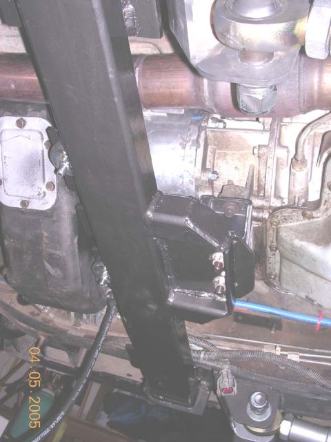 1994 Ford Bronco - Close-up of vehicle undercarriage showing transmission and exhaust system components.