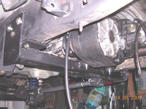 1994 Ford Bronco - The underside of a vehicle displays its drivetrain and suspension components, with a visible date stamp.
