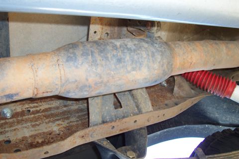 1994 Ford F-150 - Close-up view of the undercarriage, showing the exhaust system and suspension components.
