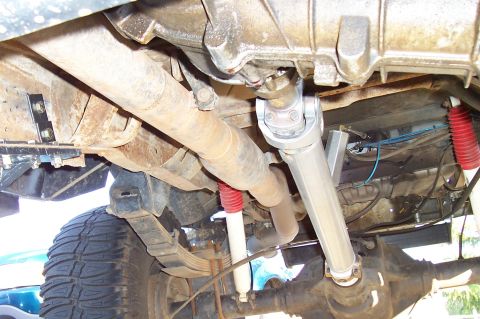 1994 Ford F-150 - The underside of a truck reveals its exhaust system, driveshaft, and suspension components.