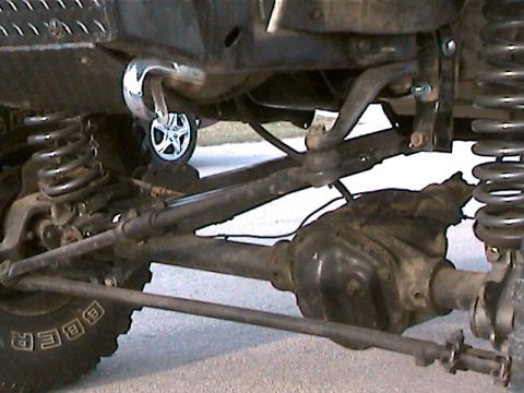 1977 Ford F-150 - Undercarriage view of a truck, showing suspension, differential, and tire details.