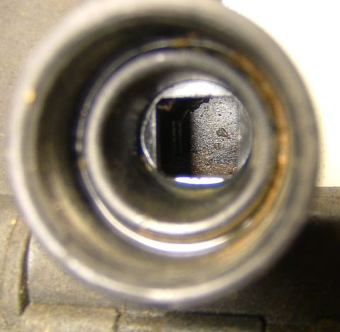 1987 Ford Bronco - Close-up view of the inside of a radiator cap opening, revealing a square internal component.