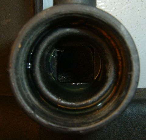 1987 Ford Bronco - The interior of a radiator hose connection is visible, with a dark, square opening at the end.