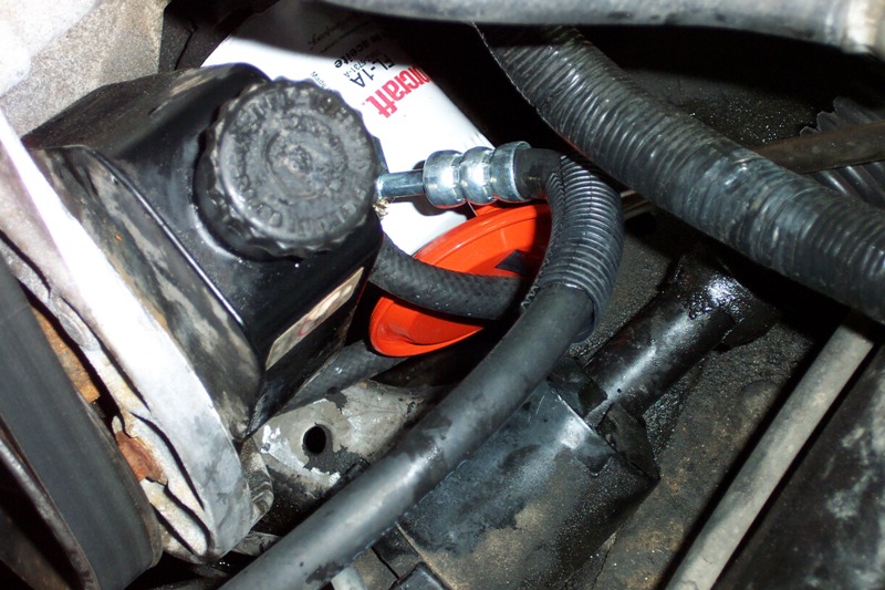 Saginaw pump installed; the orange thing is the power steering filter.  This is with one of the earlier hoses that did not work.
