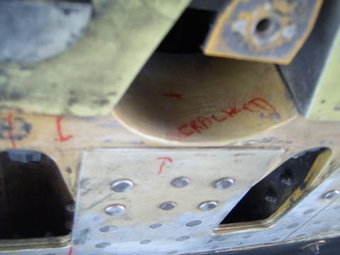 1988 Ford Bronco - Close-up of vehicle undercarriage with 'CRACKED' written in red marker.