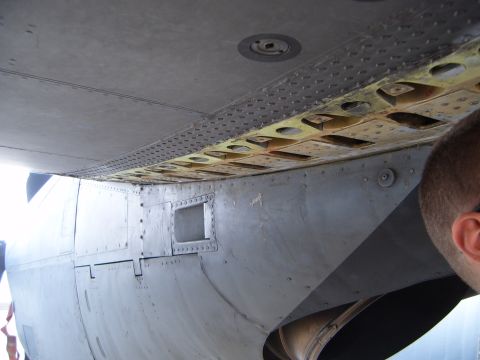 1988 Ford Bronco - The underside of an aircraft wing shows its complex internal structure and riveted panels.
