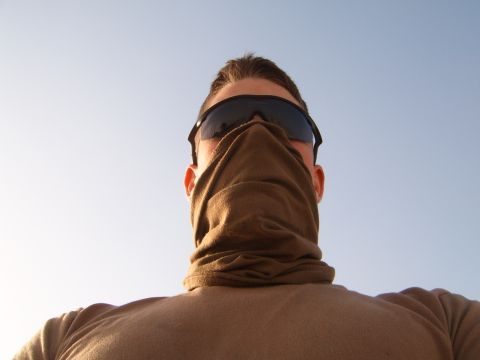 1988 Ford Bronco - A person is seen from behind, wearing sunglasses and a brown face covering against a clear blue sky. The Supermotors logo is visible in the…