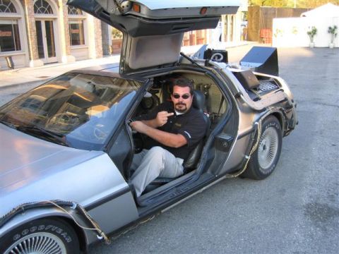 1994 Ford Bronco - A man sits in a DeLorean, modified to resemble the time machine from the Back to the Future movies.