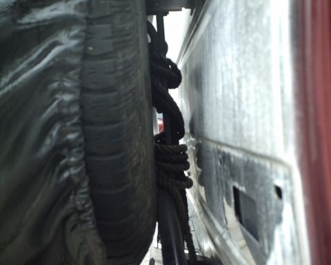 1987 Ford Bronco - A close-up view of a spare tire and rope, possibly for off-road recovery, is visible.