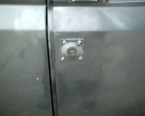 1987 Ford Bronco - Close-up of the door panel on a 1987 Ford Bronco, showing a square metal plate.
