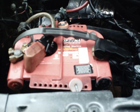 1987 Ford Bronco - A red Optima car battery is visible in the engine bay, connected to various cables.