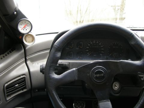 1990 Ford Probe - The interior of a car is shown, focusing on the steering wheel and dashboard elements.