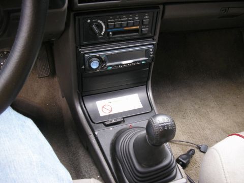 1990 Ford Probe - The interior of a car is visible, focusing on the center console and gear shifter, with no clear year identification.