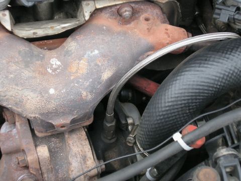 1990 Ford Probe - This image shows a close-up view of an engine's exhaust manifold and surrounding parts.