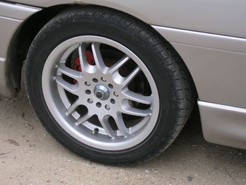 1990 Ford Probe - A close-up view of a car's wheel and tire, highlighting the alloy rim design.