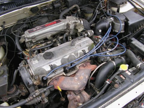 1990 Ford Probe - Close-up view of a car's engine bay, showing various components and wiring.