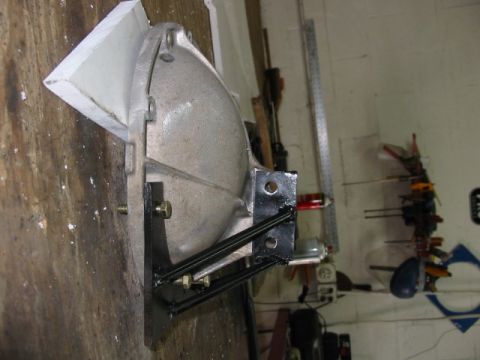 1985 Ford LTD Crown Victoria - A close-up view of a transmission bell housing, likely a spare part, mounted on a custom bracket in a workshop.