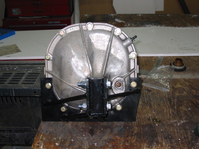 Differential housing mounted on a black bracket with bolts