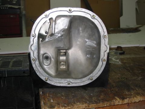 1985 Ford LTD Crown Victoria - A differential cover is shown, with visible bolts around its perimeter.