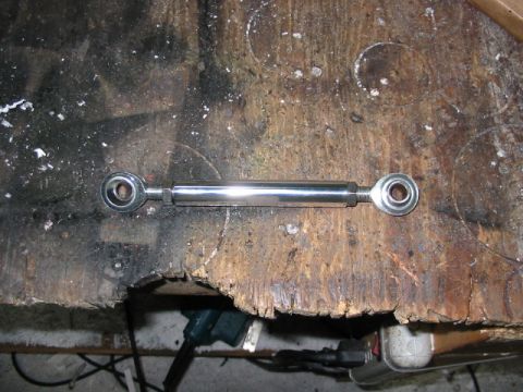 1985 Ford LTD Crown Victoria - A chrome adjustable linkage with rod ends is shown on a wooden workbench surface.