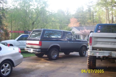 1979 Ford F-150 - A gray and blue Ford Bronco is parked in a driveway with other vehicles.
