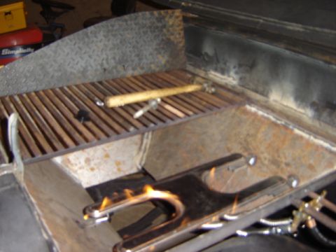 1992 Ford Bronco - A grill with a metal grate and flames is shown.