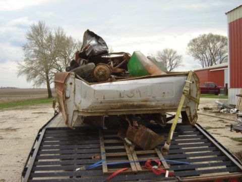 1992 Ford Bronco - A heavily damaged white truck bed, possibly from a 1979 Ford F-250, is secured to a trailer for transport.
