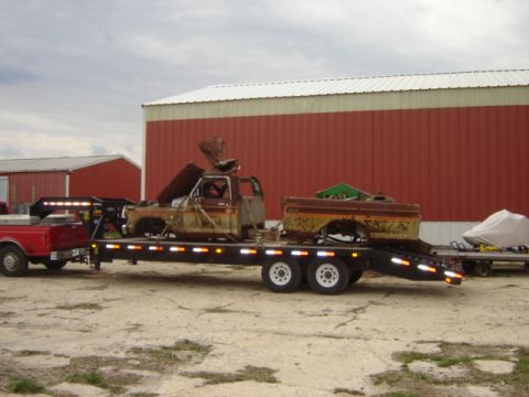 1992 Ford Bronco - A heavily rusted 1978 Ford F-250 truck cab and bed are transported on a flatbed trailer.