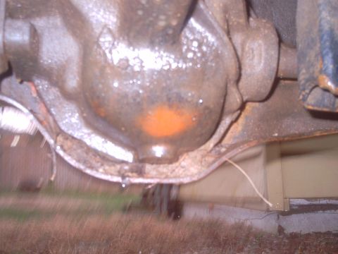 1985 Ford Bronco - Close-up view of a vehicle's rear axle differential, showing an orange marking.