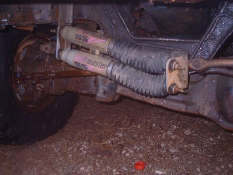 1985 Ford Bronco - The photo shows the rear suspension of a vehicle, dual shock absorbers and steering components.