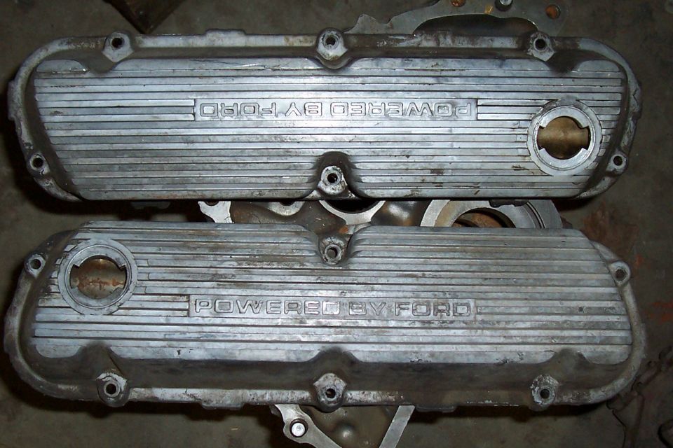 Two aluminum valve covers with "POWERED BY FORD" embossed on them