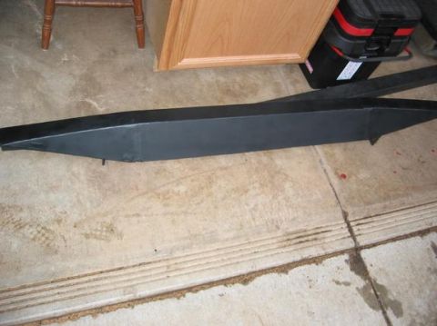 1991 Ford Explorer - A black bumper is shown on a concrete floor, with a wooden cabinet and a toolbox in the background.
