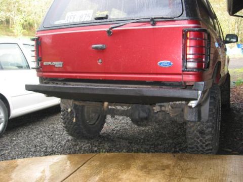 1991 Ford Explorer - Rear view of a red 1991 Ford Explorer, showing the tailgate, aftermarket bumper, and license plate YFF 875.