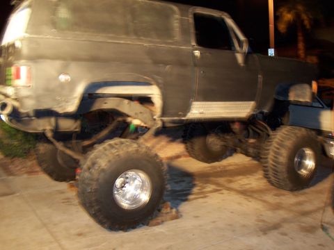 1994 Ford Bronco - This modified SUV sits high on large tires, suggesting off-road capability or a custom build.