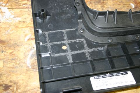 2003 Jeep TJ - Close-up of a black plastic trim panel showing adhesive residue and a manufacturer's label.