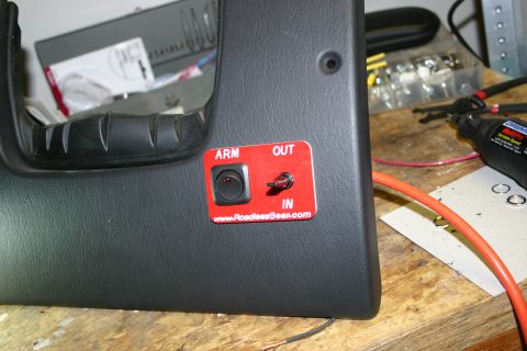 2003 Jeep TJ - Aftermarket winch control switch panel installed on a vehicle's interior dash panel.