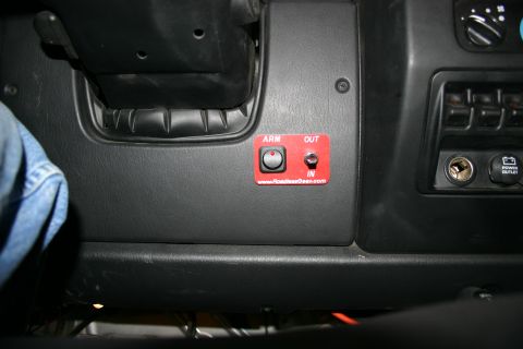 2003 Jeep TJ - Aftermarket switch panel and power outlet installed on a vehicle's dashboard.