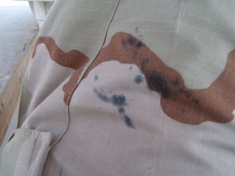 1988 Ford Bronco - Close-up of desert camouflage fabric showing dark stains.