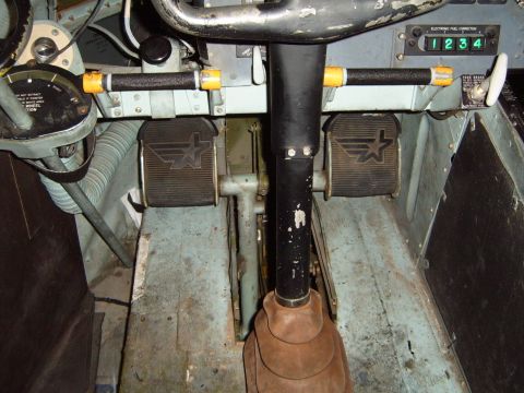 1988 Ford Bronco - Interior view of a cockpit with pedals and a digital fuel correction display.