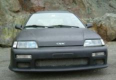 1995 Ford F-150 - Front view of a matte black Honda Civic with an aftermarket bumper.