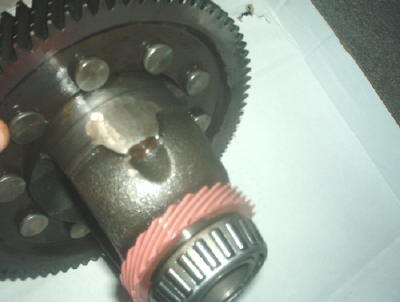 1994 Mazda MX-3 - This image shows a close-up view of a damaged differential gear assembly, including a bearing and a large gear.