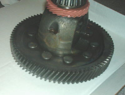 1994 Mazda MX-3 - Close-up of a differential gear assembly, showing the intricate teeth of the ring gear and a bearing.