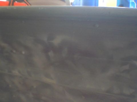 1986 Ford Bronco - The image shows a close-up of a gray painted metal surface, possibly a vehicle panel, with a Supermotors.net watermark visible in the lower…